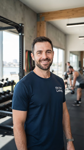 Portrait headshot of friendly male strength coach with short beard in dark navy shirt in modern Geelong daylight gym environment.